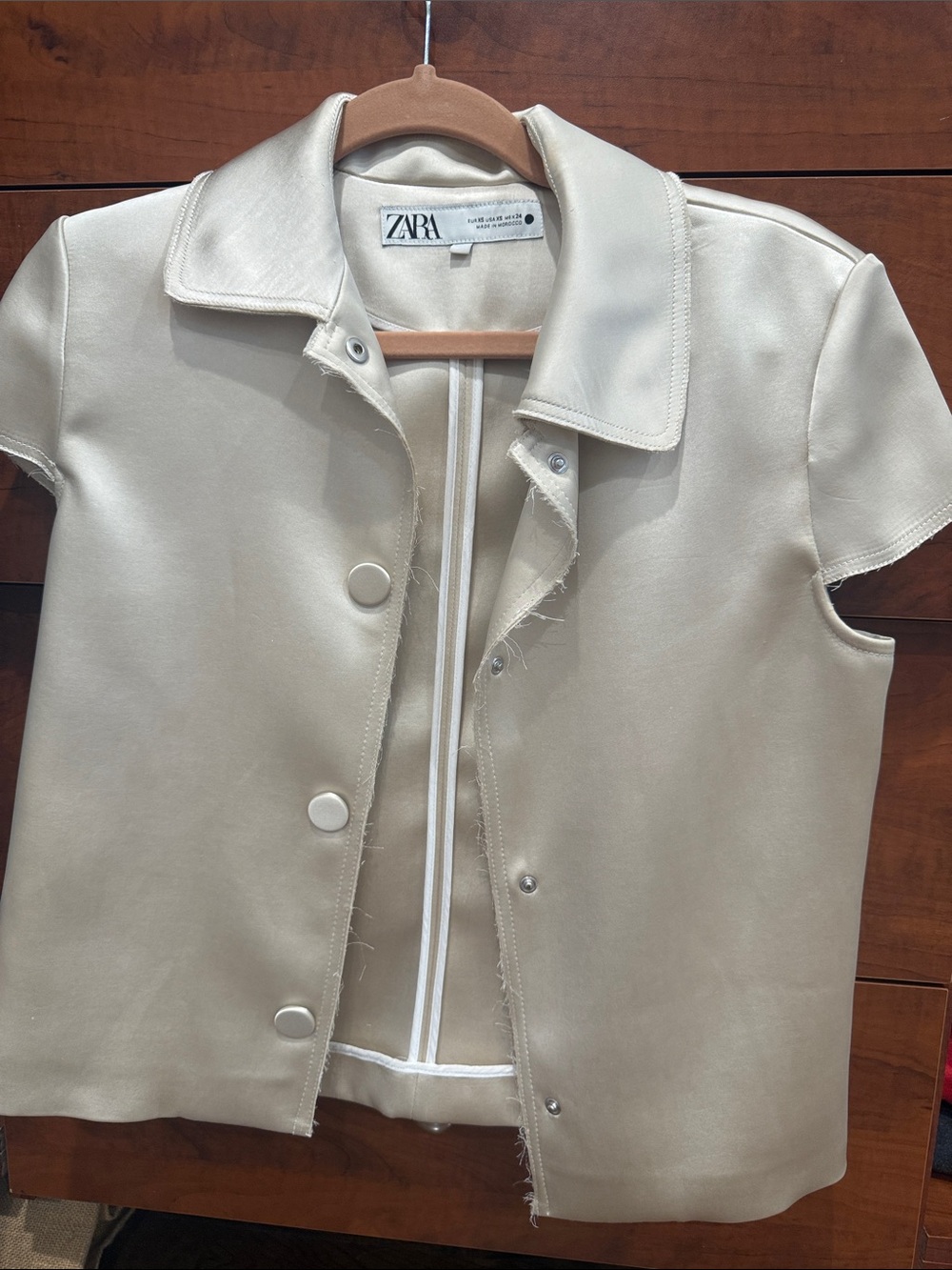 ZARA Cream Short-Sleeve Snap Front Jacket silky feel but Made of polyester.